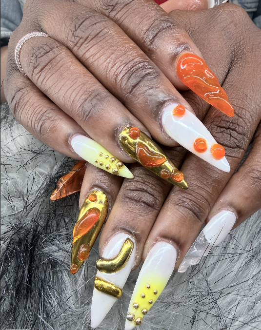 Orange and gold sculpted nail design